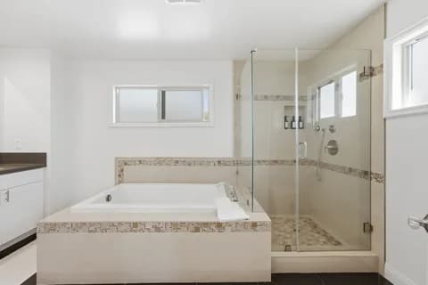 6522 N Golden West Ave — bathroom with tub and glass shower